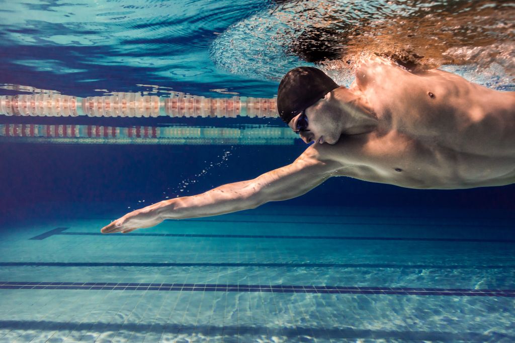imagem subaquática de um homem nadando em uma piscina olímpica