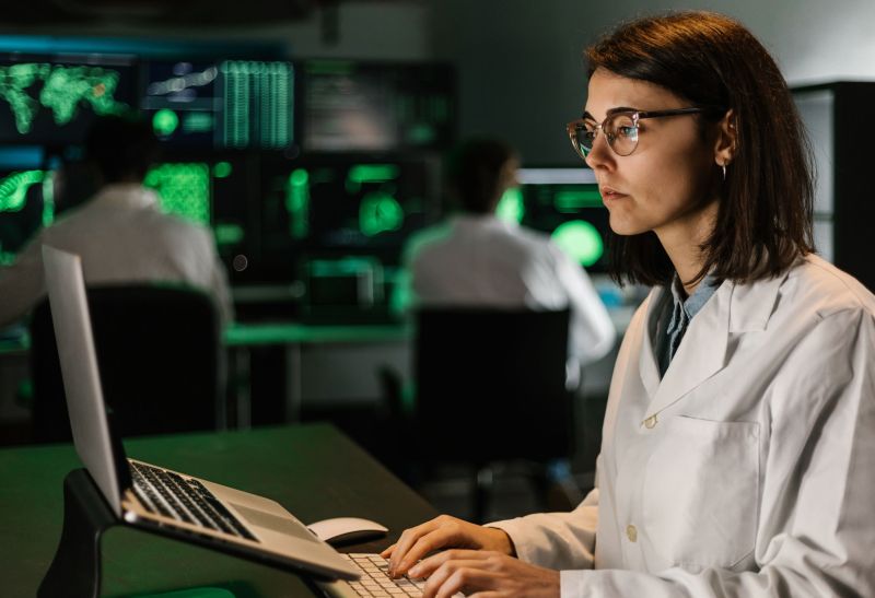 Female scientific research using laptop computer in laboratory - Professional health care biotechnologist woman working during investigation